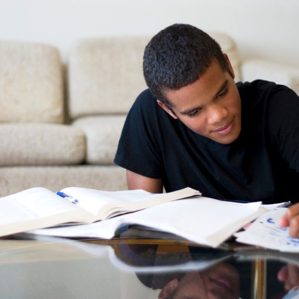 16 year old boy working on his homework.